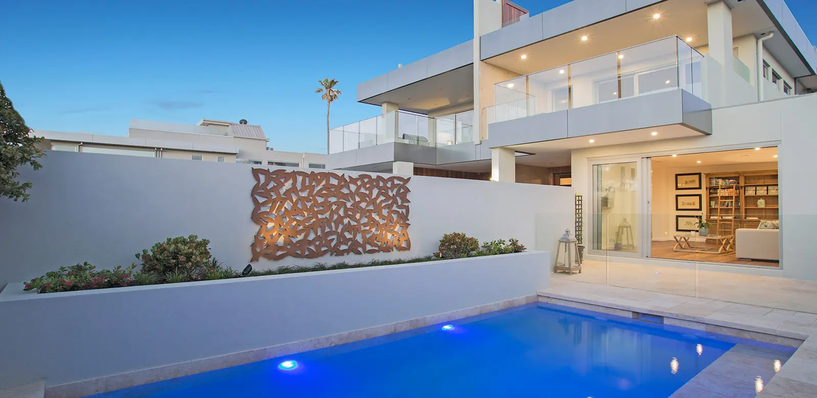 Small concrete plunge pool with clear blue water and surrounding greenery. Perfect for a refreshing dip.