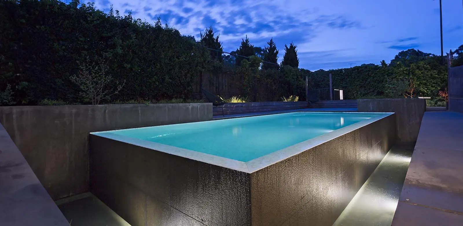 Modern swimming pool at evening with negative edge