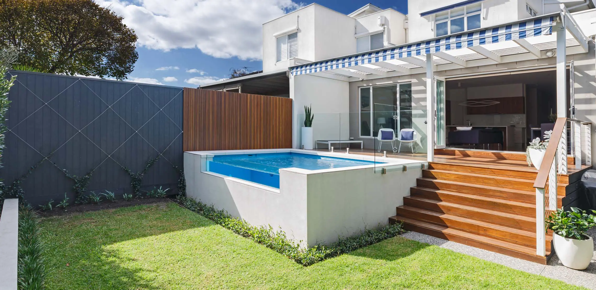 A serene plunge pool surrounded by lush greenery, offering a refreshing escape from the heat